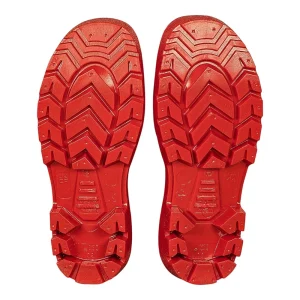 Close-up view of the bright red, non-slip, lugged soles of the pair of waders